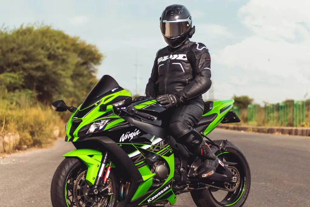 Person With Black Helmet Riding a Kawasaki Motorbike