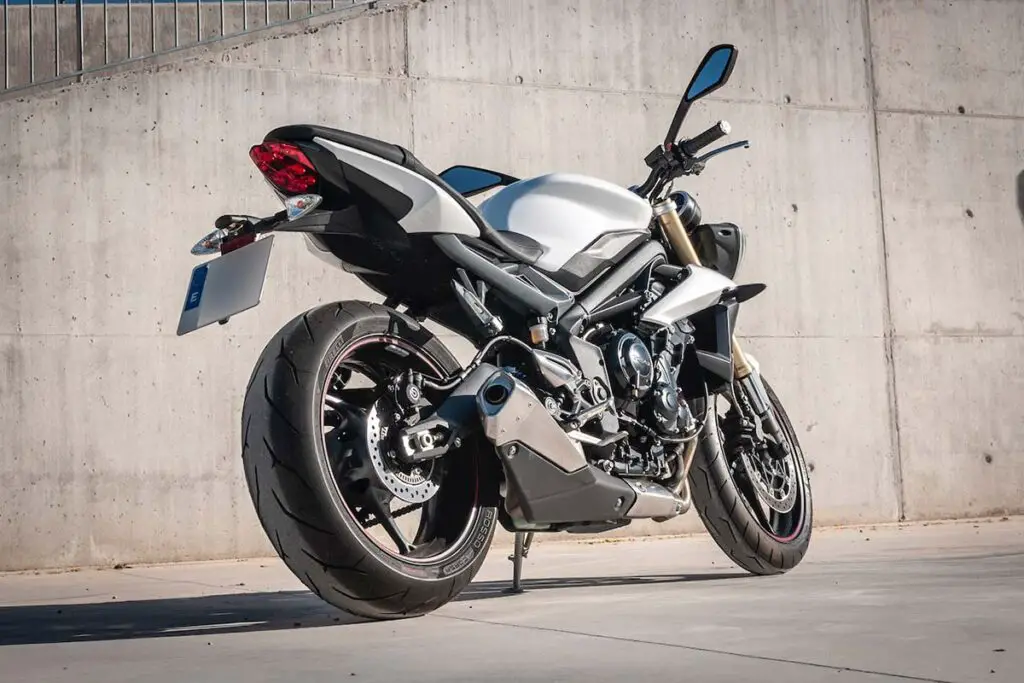 Motorcycle Parked Beside Gray Concrete Wall