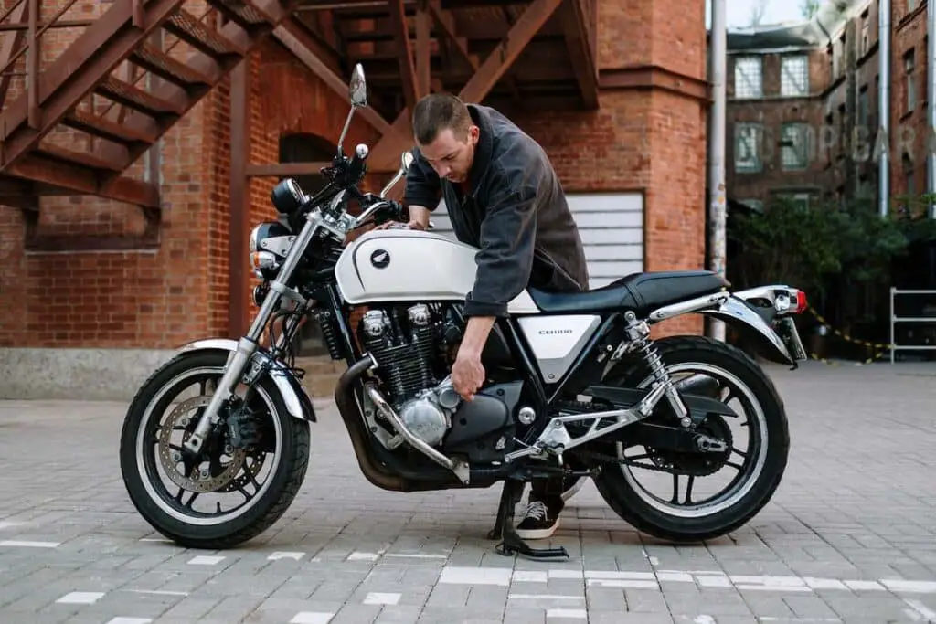 Person Inspecting Motorcycle