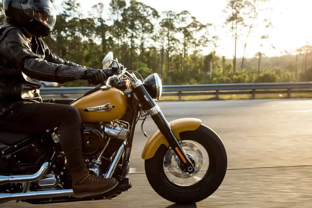 Person Riding a Yellow Harley Davidson Motorcycle