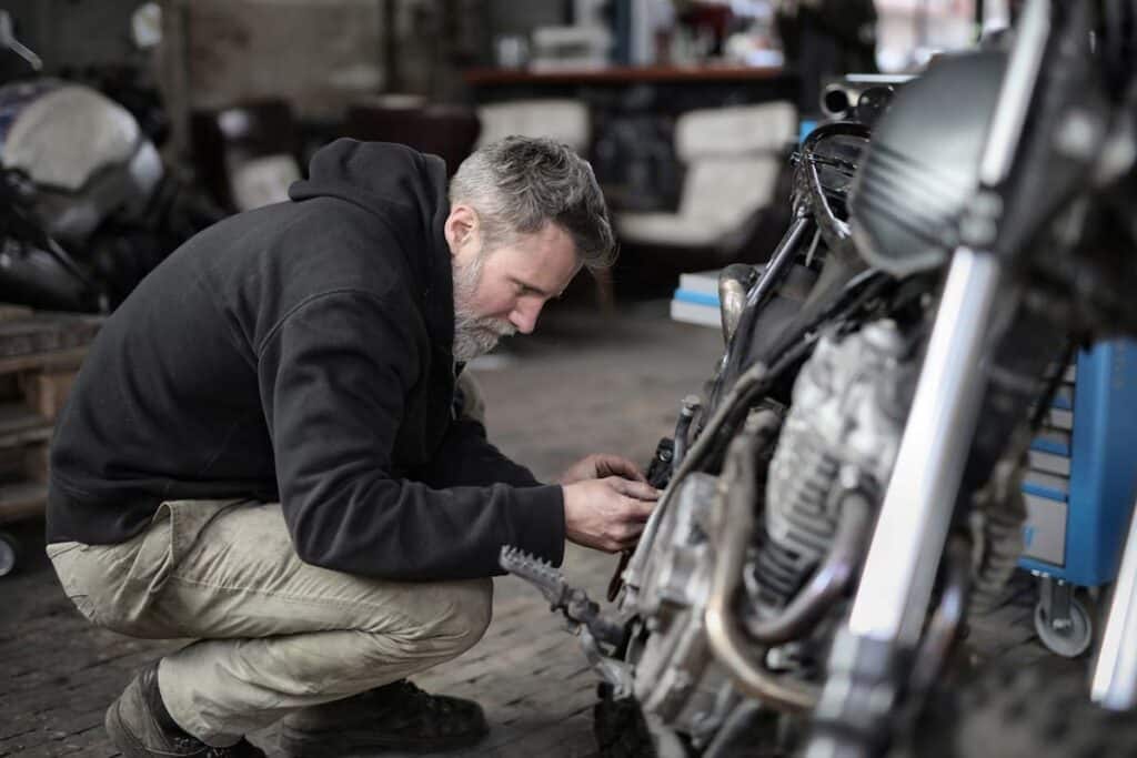 Person Working on a Motorcycle in a Garage