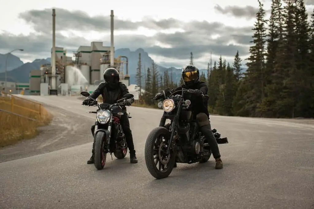 Two People Riding Motorcycles on a Road