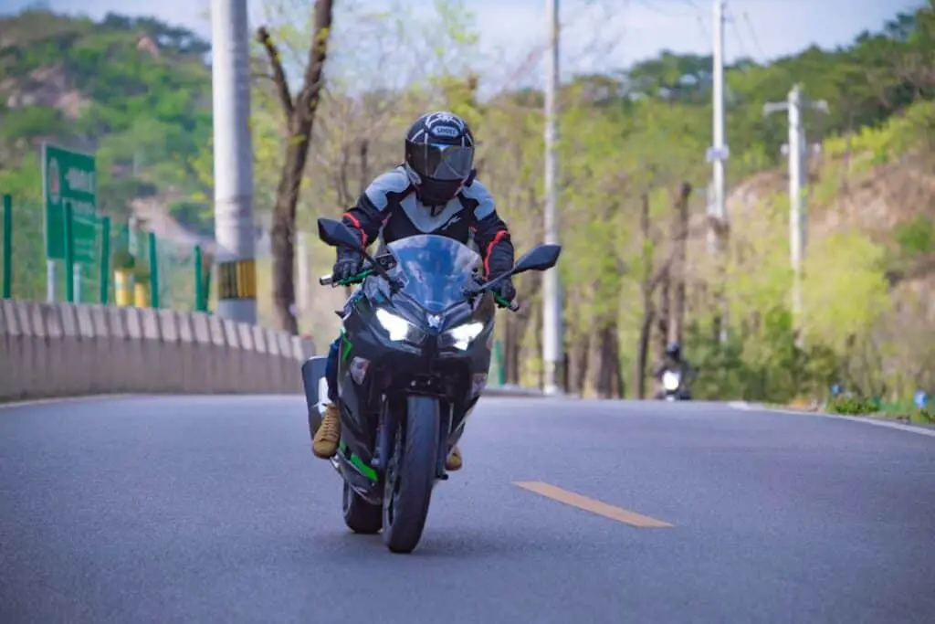 Person Riding a Motorbike on the Road