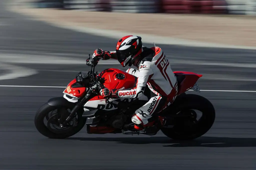 Person Riding a Red Ducati Motorcycle