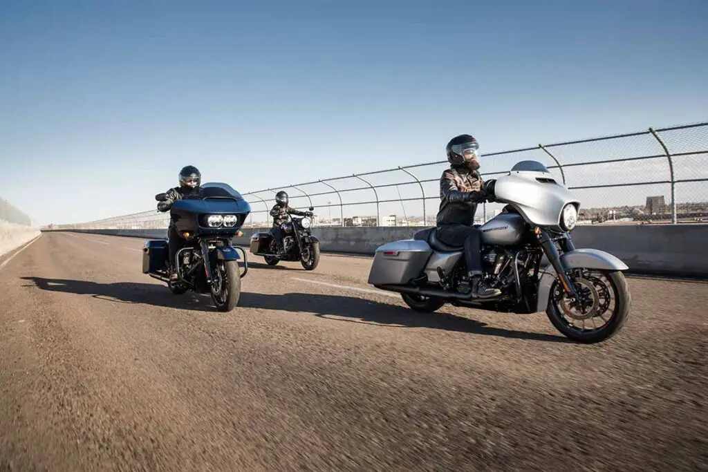 Three People Riding Touring Motorcycles