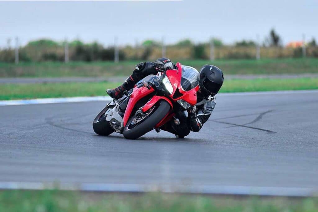 Person Riding Red Motorcycle