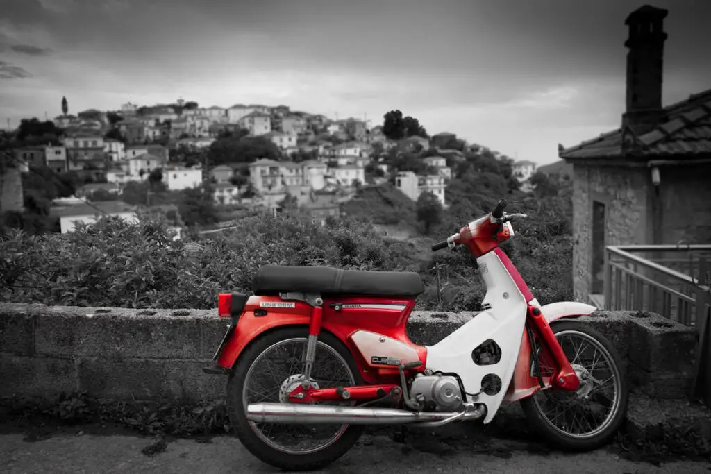 Red and White Honda C90 Motorcycle