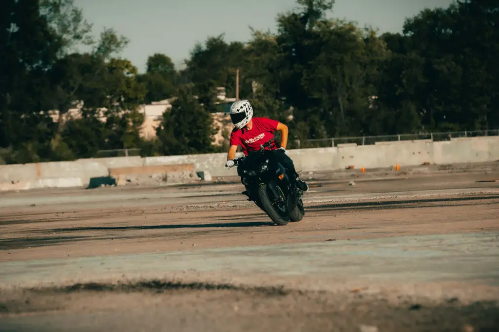 Person With Red Shirt and White Helmet Riding Motorcycle