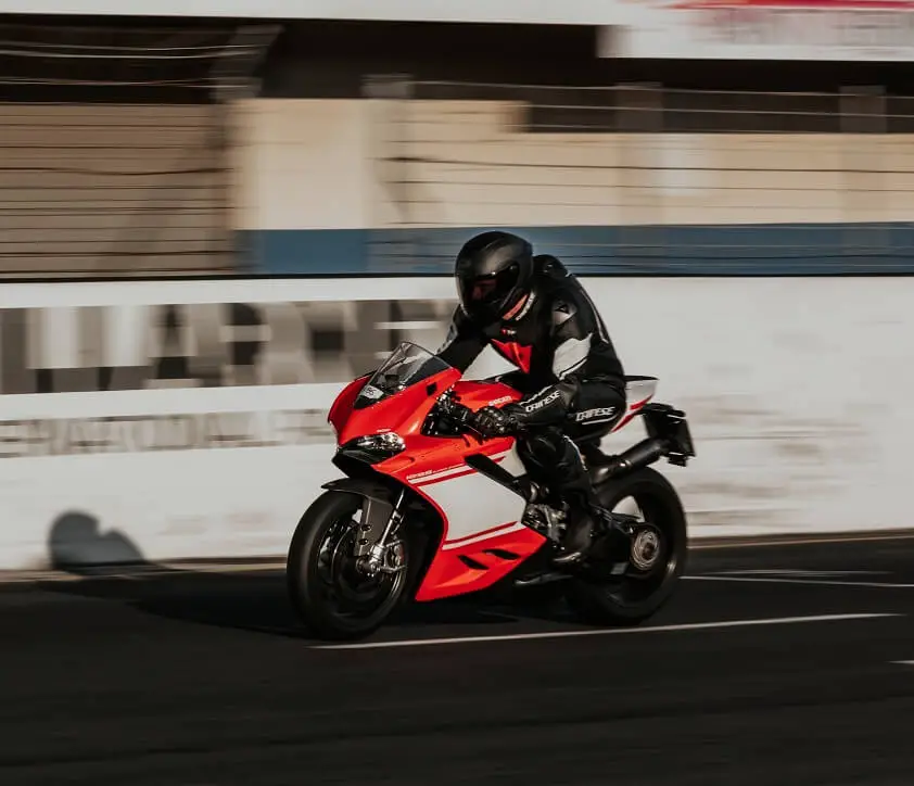 Man Riding Red and White Ducati 1299 Superleggera